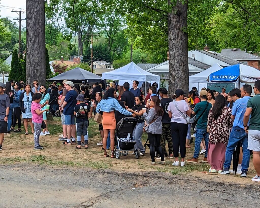 Attendees lining up for delicious Filipino food at the first Fil-Am Spring Fest 2023 in Fairfax, Virginia, celebrating culture, community, and cuisine.